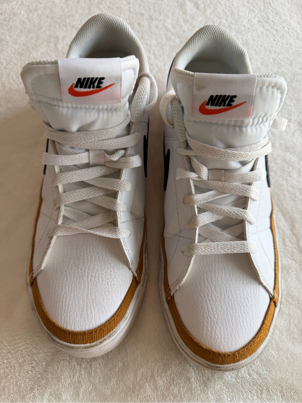 Nike White Sneakers with Orange Trim and Black Swoosh